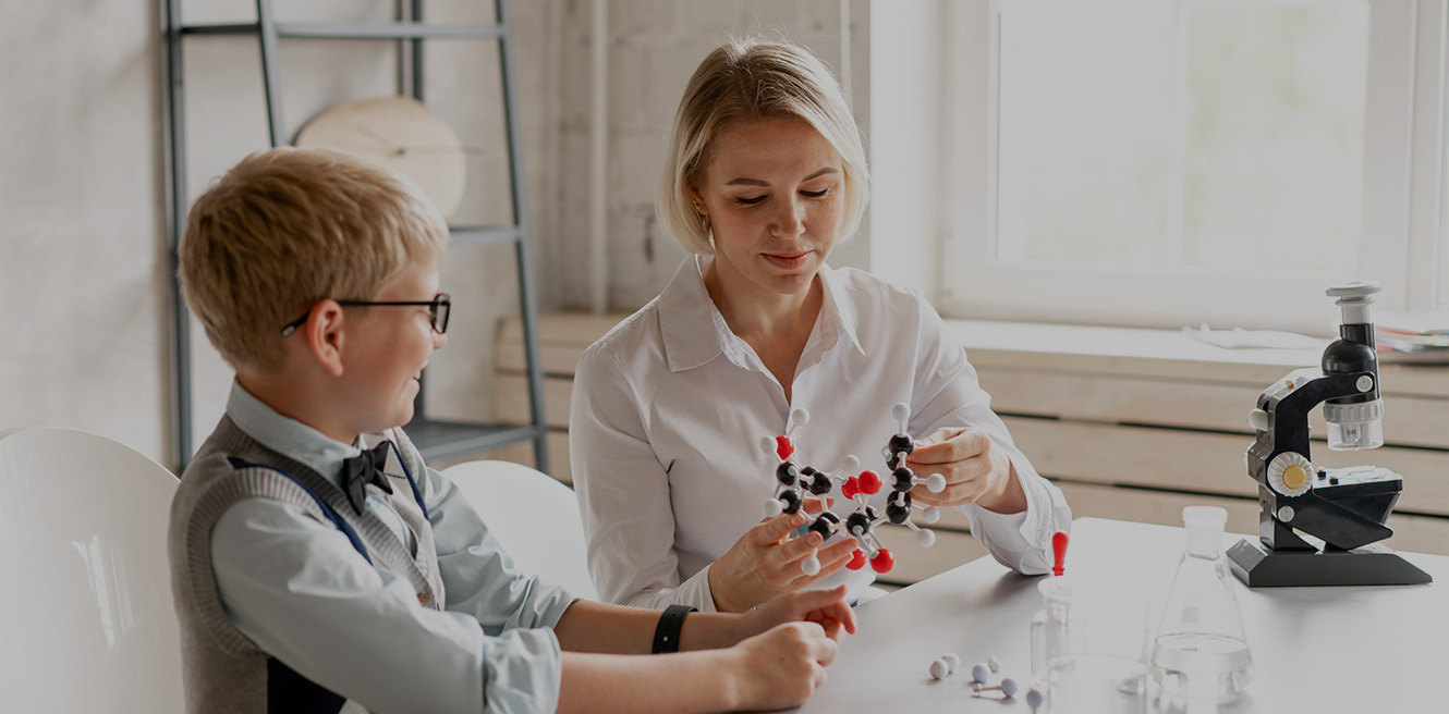 Female science tutor in San Francisco studying chemistry with student